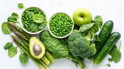 Fresh green vegetables and fruits on white background.