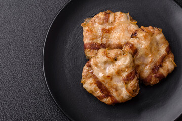 Round minced chicken or pork cutlet wrapped in bacon with salt, spices and herbs