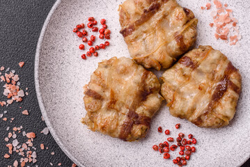 Round minced chicken or pork cutlet wrapped in bacon with salt, spices and herbs