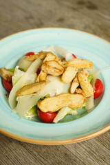 Caesar salad with grilled chicken stripes and cheese