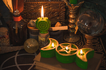 Fototapeta na wymiar Healing of Anahata heart chakra. Green candles for mental health. Esoteric concept, cleaning of negative energy