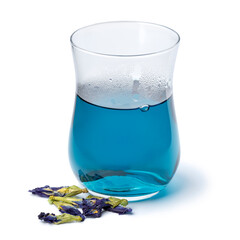 Tea glass with Butterfly pea flower tea and dried butterfly pea tea flowers close up isolated on white background