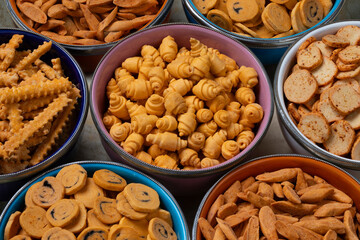 Colorful bowls with a variation of traditional Moroccan Krichlate spicy miniature shortbread cookies close up