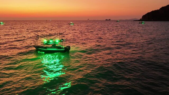 Squid fishing boat Turn on the squid lure light after sunset. Fishing boat go to ocean for catching fish all a long night - at Thailand. Top view of Fishing Boat 