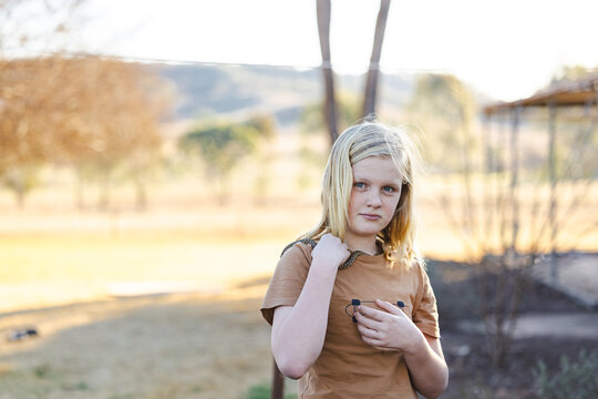 Pre-teen adolescent boy holding pet children's python snake