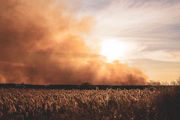 Fensteraufkleber attack and drone strike on an oil and gas pipeline during the war, causing a large fire against the blue sky at sunset © Torkhov