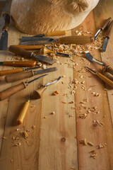 Carving wooden furniture. Carpenter using tool making artistic wood carving