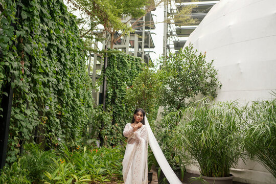 south Asian, wedding photography, woman, Christian wedding, outdoor, beautiful natural background , beautiful tropical plants in a background of wedding woman
