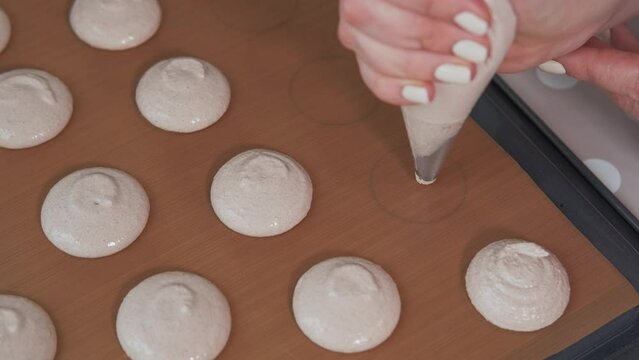 Video of pastry chef making cookies for macaroons.
