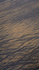 Beautiful sand pattern formed by yellow and black grains in muttom beach
