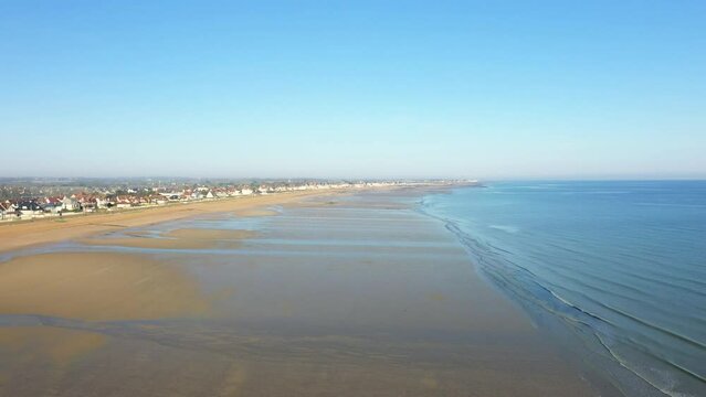 The immense beach of Sword beach and the Channel Sea in Europe, in France, in Normandy, towards Caen, in Lion sur Mer, in spring, on a sunny day.