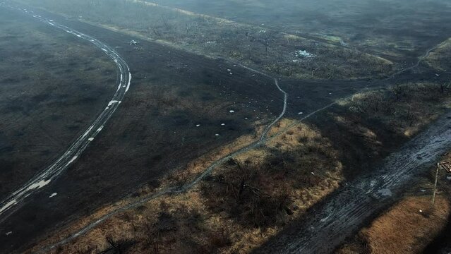 Battlefield in Ukraine. Aerial photography of a field with trenches and explosion craters.