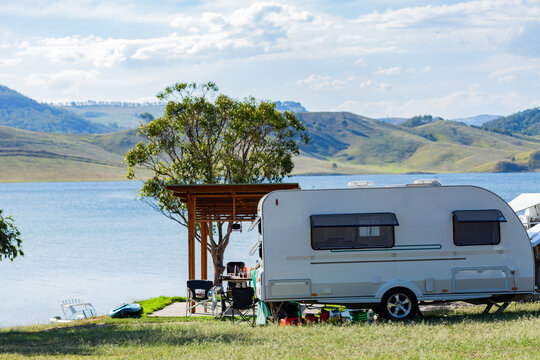 Caravan beside inland lake in recreational area for a holiday