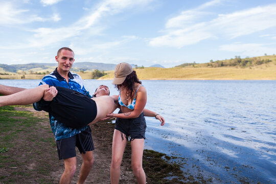 Group of Aussie teens being silly together by the water on a summer afternoon