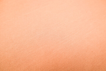 Light gradient paper backdrop, trendy peach fuzz color. Textures formed by cardboard or paper ancient of color soft orange.