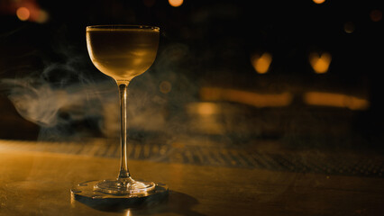 Elegant cocktail on bar with smoke