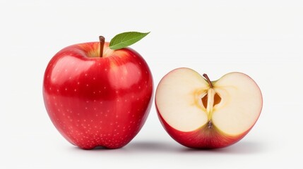 One whole and one half red apple with a green leaf on a white background.