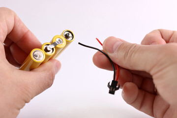 The cable is disconnected from the battery. Power loss concept. Repair of small electronics.