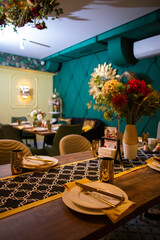 Elegant restaurant table setting with floral centerpiece and copper accents