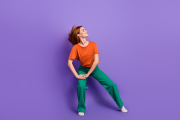 Full length photo of cheerful funky glad girl dancing enjoying rhythm chill vibe isolated on purple color background