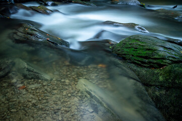 Close up of water in stream Hylaty torrent, fresh water flowing around boulders, long exposure photography, Bieszczady
