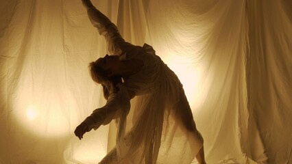 Silhouette contemporary experimental choreography concept. Female dancer performing in the studio....