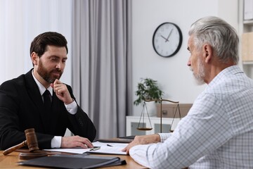 Senior man having meeting with lawyer in office