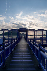 Obraz premium View of the bridge at the seaside during sunset