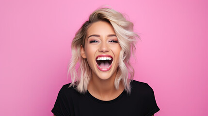 a beautiful blonde woman wearing black shirt expressing happiness emotion with her mouth laughing and big wide open eyes. isolated on pink background