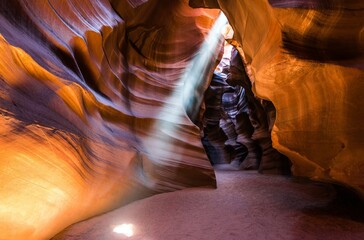 A Light Shines Through a Narrow Slot in a Canyon