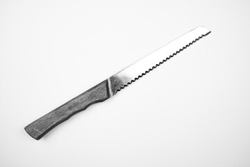 Knife with a wooden handle on an isolated background. The knife is serrated.