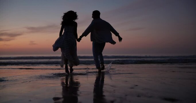Sunset, holding hands and shadow of couple at beach on vacation, adventure or holiday for romantic date. Love, silhouette and back of people run on tropical weekend trip for valentines day together.