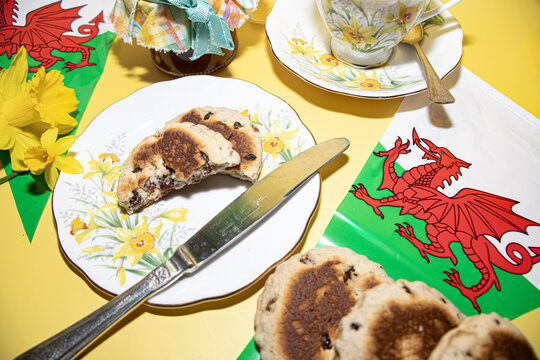 St davids  day  celebrations welsh  Flags  Welsh cake  Daffodils   Vintage  tea  party  and  teacup  on a yellow  back ground 