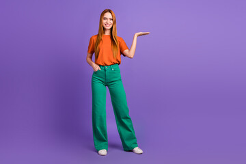 Full length photo of young foxy ginger girl hold on palm her wish list to buy demonstrate boyfriend isolated over violet color background