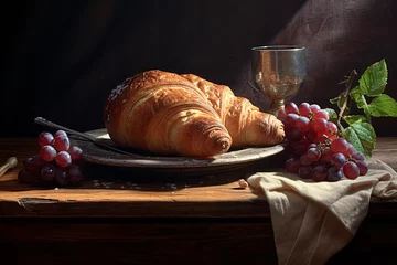 Fotobehang a croissant and grapes on a plate © Vasile