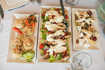 Top view of beautifully set table with meat, cold appetizers on table in restaurant. 