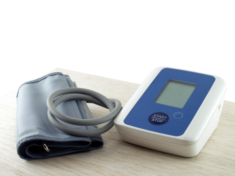 portable electronic blood pressure monitor on desk corner isolated on transparent