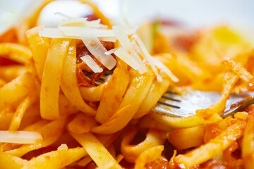 Traditional tagliarini pasta with tomato sauce, sausage and parmesan cheese