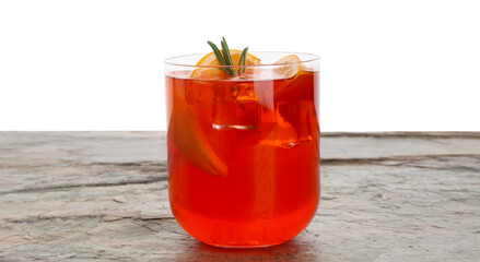 Aperol spritz cocktail, orange slices and rosemary in glass on grey textured table against white...