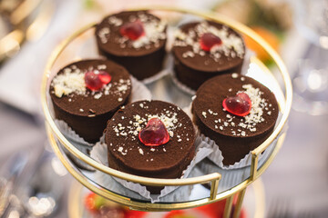 Enjoyment of taste. Chocolate desserts desserts on round tray at wedding, holiday.Cakes to order.