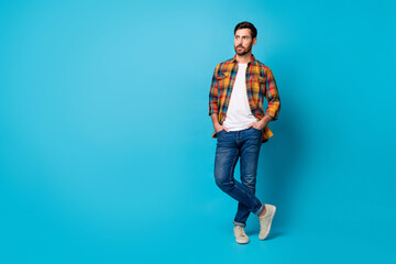 Full length photo of serious guy wear checkered shirt denim pants look at proposition empty space...