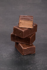 Delicate dessert. Chocolate souffle in chocolate glaze. Bird's milk. Dark gray background Close-up