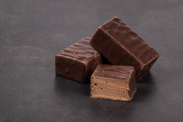 Vegan Candies. Chocolate souffle in chocolate. Dark gray background. Close-up. Copy space