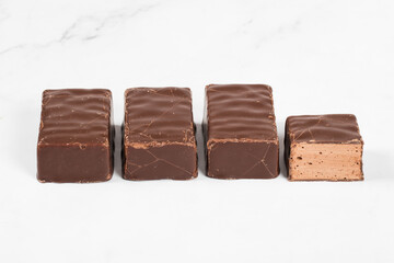 Candies. Chocolate souffle in chocolate. White background. Close-up