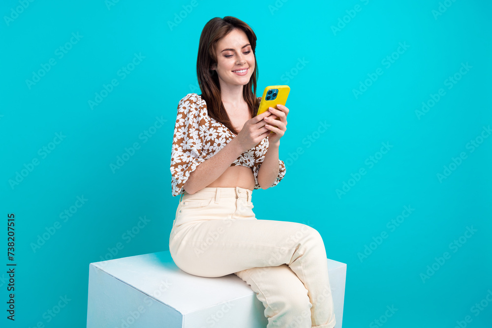 Sticker photo of sweet adorable lady dressed flower print top sitting cube chatting modern device isolated t