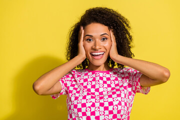 Photo of astonished positive person hands touch head empty space isolated on yellow color background