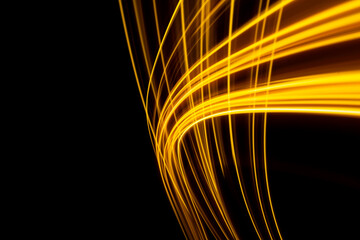 a long exposure photo of a yellow light trail on a black background. High quality