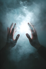 Conceptual photo of hands breaking through a barrier of fog, visualizing the process of overcoming mental obstacles


