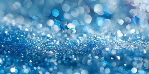 A close-up of sparkling blue crystals with a bokeh light effect.