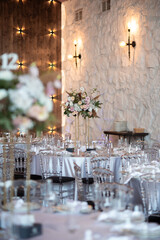 Luxury wedding table setting with flower centerpieces and candles